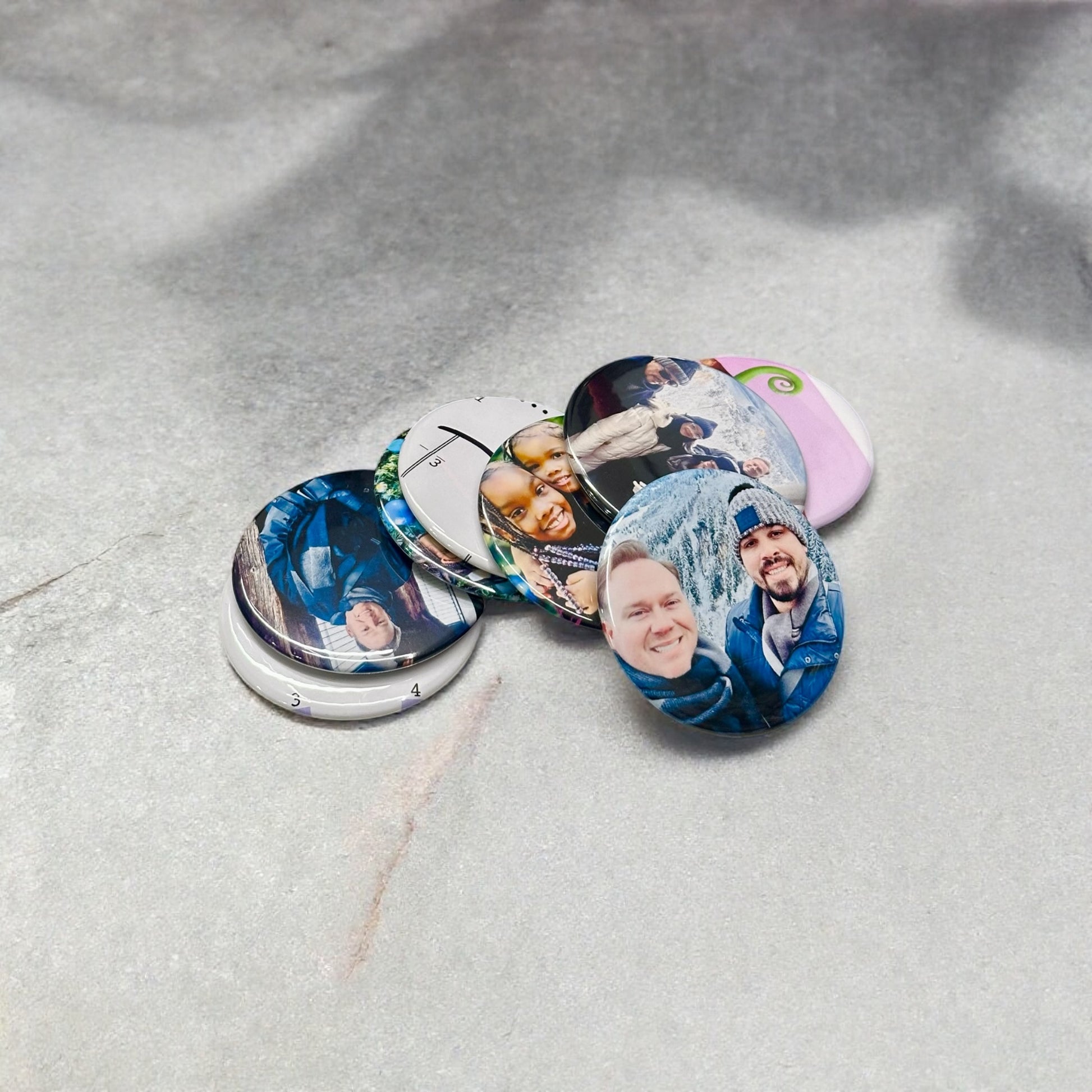 Personalized custom photo magnets displayed on a refrigerator door, featuring various family photos, travel snapshots, and pet pictures, each printed on round magnets with a glossy finish.