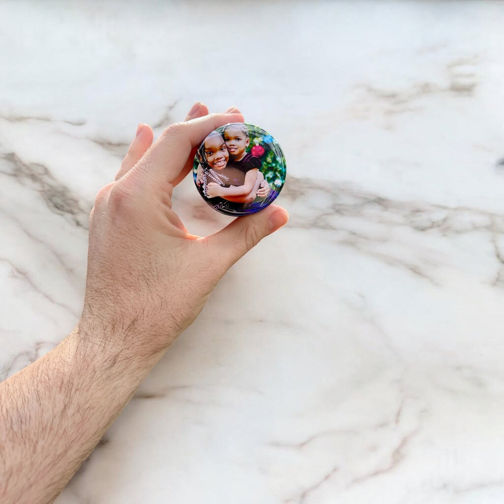 Personalized custom photo magnets displayed on a refrigerator door, featuring various family photos, travel snapshots, and pet pictures, each printed on round magnets with a glossy finish.