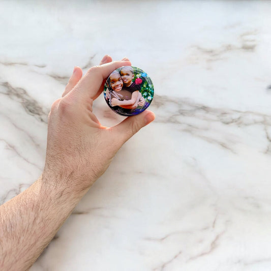 Personalized custom photo magnets displayed on a refrigerator door, featuring various family photos, travel snapshots, and pet pictures, each printed on round magnets with a glossy finish.