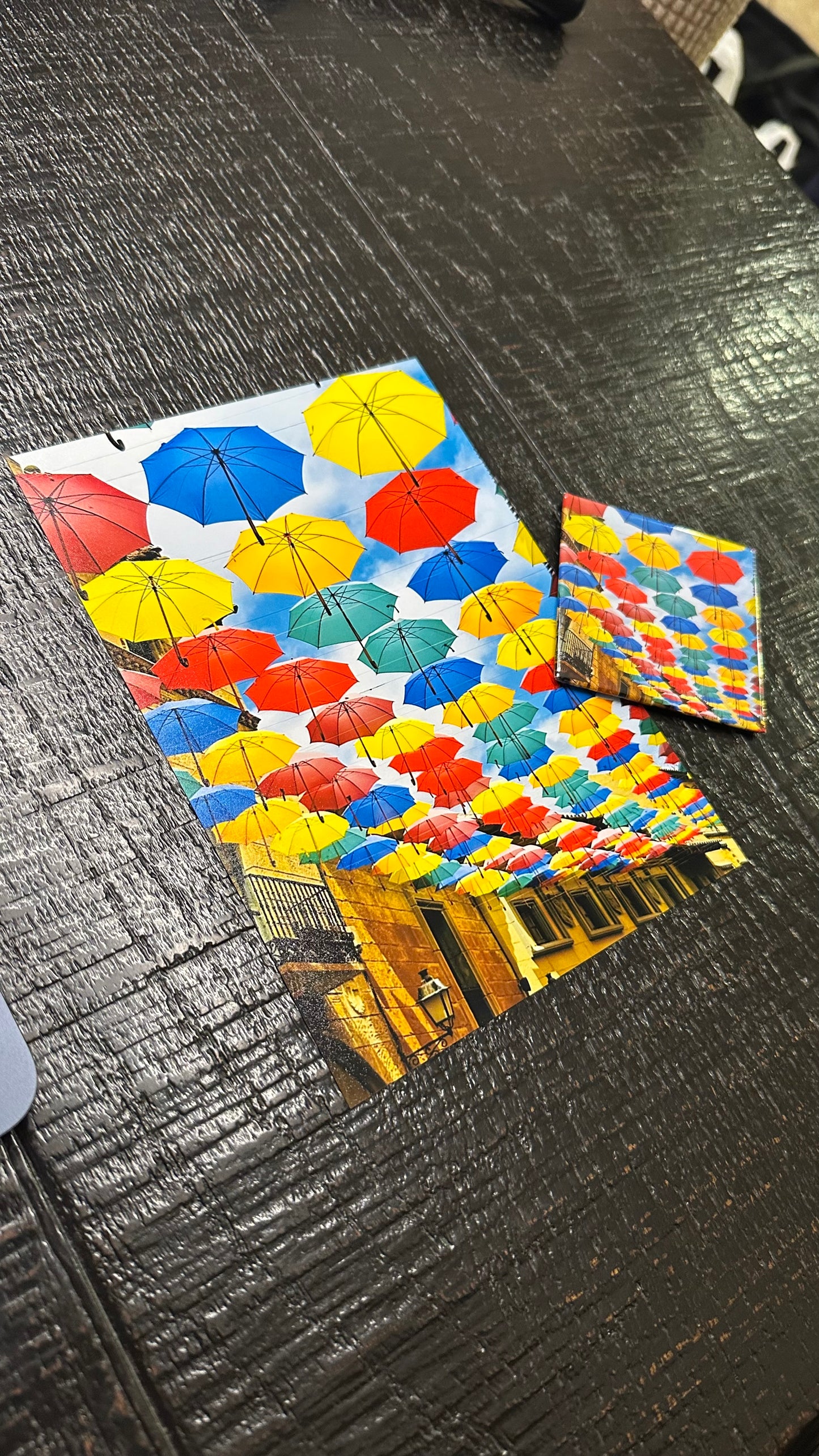 Colorful umbrella patterned paper on a textured surface