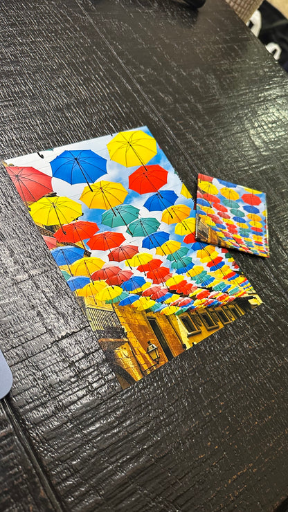 Colorful umbrella patterned paper on a textured surface